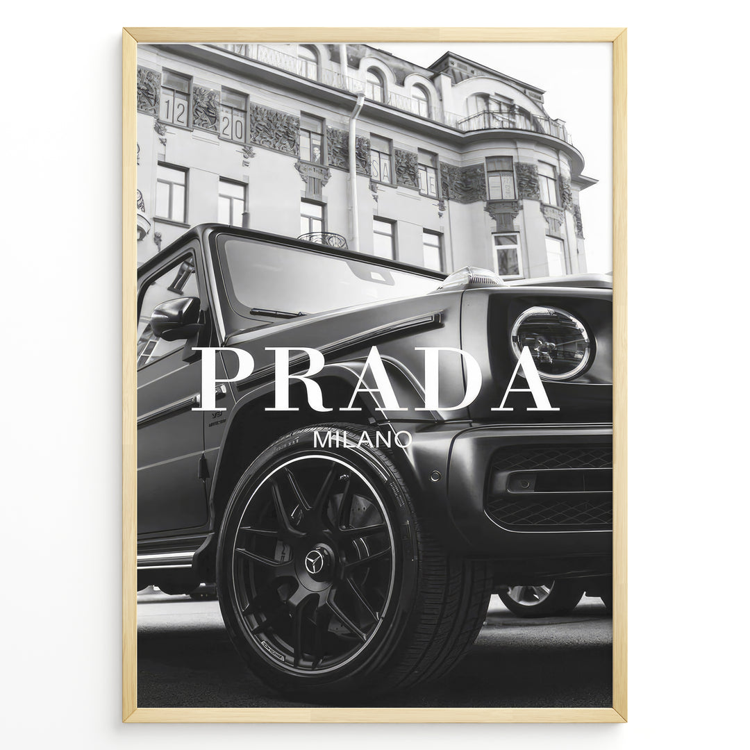 Fashion Plakat | Luxury Lifestyle: Mercedes G-Wagon x Prada Milano Wall Art Plakaty.dk | Black and white framed photo of a Mercedes G-Wagon with Prada Milano text overlay, parked in front of ornate historic buildings.