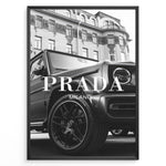 Indlæs billede til gallerivisning Fashion Plakat | Luxury Lifestyle: Mercedes G-Wagon x Prada Milano Wall Art Plakaty.dk | Black and white framed photo of a Mercedes G-Wagon with Prada Milano text overlay, parked in front of ornate historic buildings.
