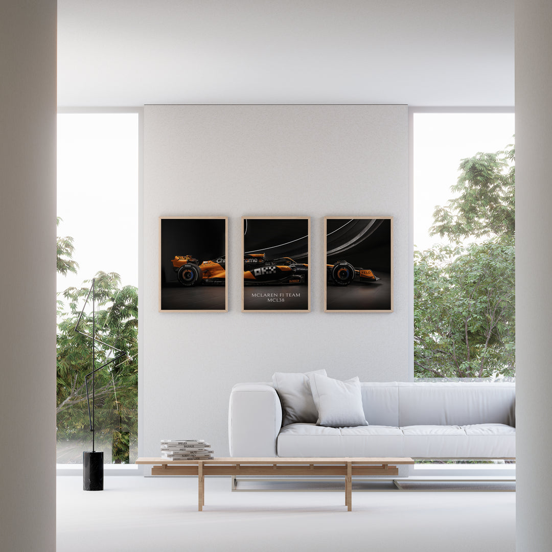 Triptych wall art plakat of the McLaren F1 Team MCL38 Formula 1 car displayed in a stylish living room with black leather furniture.