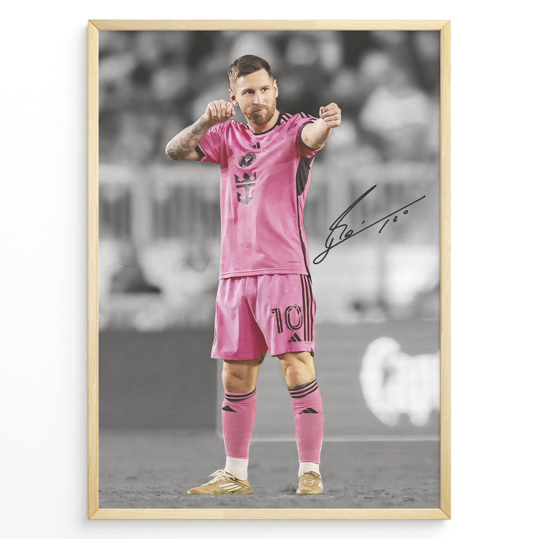 plakat of Lionel Messi in pink Inter Miami jersey pointing forward, with printed signature and black-and-white background.