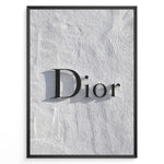 Indlæs billede til gallerivisning Fashion Plakat | Minimalist Dior Wall Sign – Timeless Fashion Statement Plakaty.dk | Minimalist black Dior logo mounted on a textured white wall, casting a soft shadow and evoking luxury and elegance.
