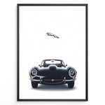 Indlæs billede til gallerivisning Framed minimalist poster of a black Jaguar E-Type classic sports car front view with the Jaguar leaping logo above on a white background.
