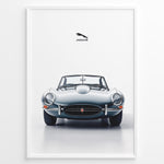 Indlæs billede til gallerivisning Framed minimalist poster of a silver Jaguar E-Type convertible classic car front view with Jaguar logo above on a white background.
