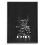 Indlæs billede til gallerivisning Fashion Plakat | Prada-Inspired Art Featuring Fierce Dog with Gun Plakaty.dk | Black Doberman with a studded collar holding a handgun in its mouth, set against a dark background with the word &quot;PRADA&quot; in bold white text.
