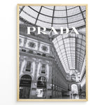 Indlæs billede til gallerivisning Fashion Plakat | Prada Boutique in Galleria Vittorio Emanuele II – Milan, Italy Plakaty.dk | Black and white photo of the Prada store inside the Galleria Vittorio Emanuele II in Milan, showcasing ornate architecture and a large glass-domed ceiling.
