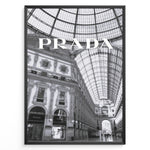 Indlæs billede til gallerivisning Fashion Plakat | Prada Boutique in Galleria Vittorio Emanuele II – Milan, Italy Plakaty.dk | Black and white photo of the Prada store inside the Galleria Vittorio Emanuele II in Milan, showcasing ornate architecture and a large glass-domed ceiling.
