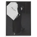Indlæs billede til gallerivisning Fashion Plakat | Prada Shopping Bag Fashion Photography Wall Art Plakaty.dk | Black and white photo of a person holding a large Prada Milano shopping bag, dressed in elegant dark clothing.
