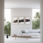 Indlæs billede til gallerivisning Triptych wall art plakat of the Red Bull Racing RB20 Formula 1 car displayed in a contemporary living room with a black leather sofa and modern furnishings.
