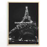 Indlæs billede til gallerivisning Fashion Plakat | Saint Laurent Eiffel Tower Poster – Black &amp; White Paris Fashion Print Plakaty.dk | Black and white photo of the Eiffel Tower illuminated at night with “Saint Laurent Paris” text overlay, capturing the essence of French fashion and elegance.
