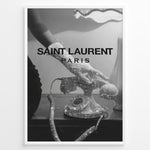 Indlæs billede til gallerivisning Fashion Plakat | Saint Laurent Glamour Art Featuring Glitter Phone and Elegant Hand Plakaty.dk | Black-and-white image of a sparkling vintage rotary phone being held by a glittering, elegant hand, with &quot;SAINT LAURENT PARIS&quot; overlaid in bold text.
