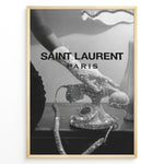 Indlæs billede til gallerivisning Fashion Plakat | Saint Laurent Glamour Art Featuring Glitter Phone and Elegant Hand Plakaty.dk | Black-and-white image of a sparkling vintage rotary phone being held by a glittering, elegant hand, with &quot;SAINT LAURENT PARIS&quot; overlaid in bold text.
