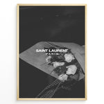 Indlæs billede til gallerivisning Fashion Plakat | Saint Laurent Paris – Monochrome Elegance Poster Plakaty.dk | Black and white Saint Laurent Paris poster featuring a bouquet of white roses wrapped in paper.

