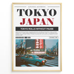 Indlæs billede til gallerivisning Japanske plakater | Blurred motion photograph of cars crossing a busy intersection in Tokyo at dusk, with bright neon signs and tall buildings in the background, framed by a poster layout with the text &quot;TOKYO JAPAN&quot; and a description of Tokyo’s city life.
