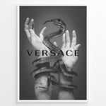Indlæs billede til gallerivisning Fashion Plakat | Versace-Inspired Art Featuring Serpent and Marble Hands Plakaty.dk | Black-and-white image of a snake wrapped around two upward-reaching marble-textured hands, with the word &quot;VERSACE&quot; overlaid in bold, semi-blurred text.
