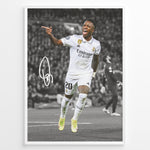 Indlæs billede til gallerivisning Framed plakat of Vinícius Jr. in a Real Madrid kit celebrating with a pointing gesture, color-highlighted against a black and white background with signature
