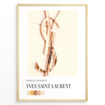 Indlæs billede til gallerivisning Fashion Plakat | Yves Saint Laurent Paris – Rose Gold Emblem Poster Plakaty.dk | Rose gold Yves Saint Laurent logo on a soft beige background with a neutral color palette and Paris/France label beneath.
