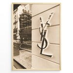 Indlæs billede til gallerivisning Fashion Plakat | Yves Saint Laurent Sepia Storefront – Vintage Luxury Wall Art Plakaty.dk | Sepia-toned photo of the Yves Saint Laurent storefront with a prominent YSL logo on a white wall and reflections of the cityscape in the background.
